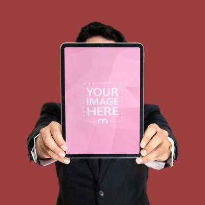 Mockup of an iPad Held by a Person